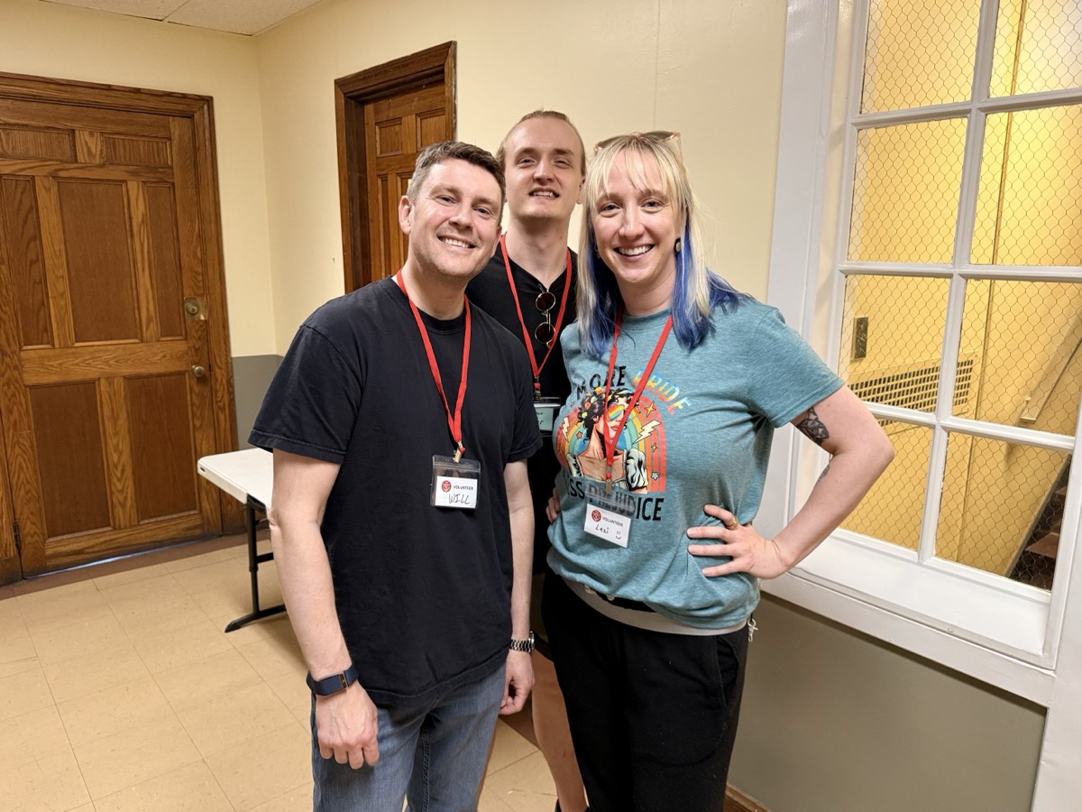 Three Good Neighbors volunteers smiling together on a pantry day